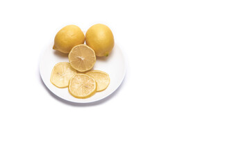 Two and a half lemons and some slices on a white background