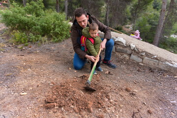 father and son planting a tree