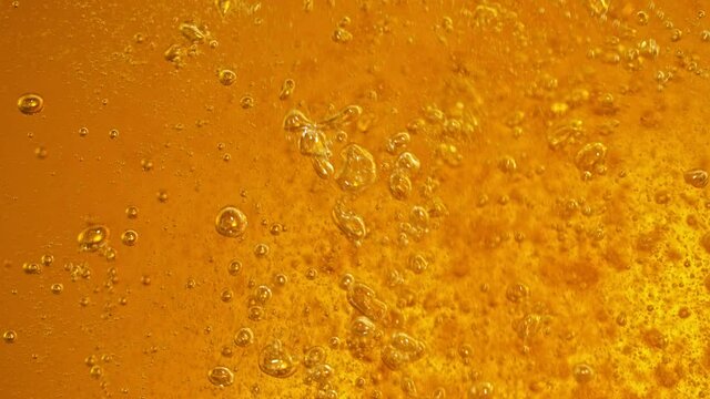 Super Slow Motion Detail Shot of Rippling Beer Bubbles in Glass at 1000fps.