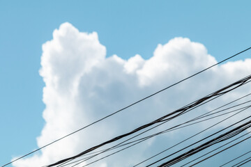 The presence of urban life in detail of a sky with electrical wires and beautiful clouds in the background.