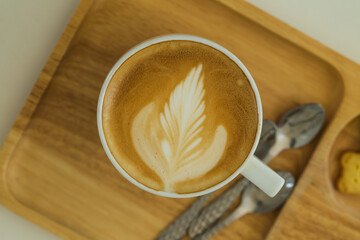 art latte  hot coffee on wooden dish