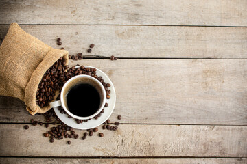 black coffee in a coffee cup top view isolated on wood background.