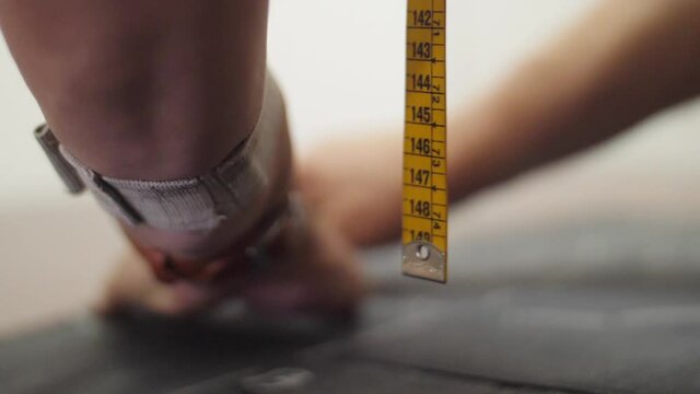 tailor using fabric to make pants slow motion