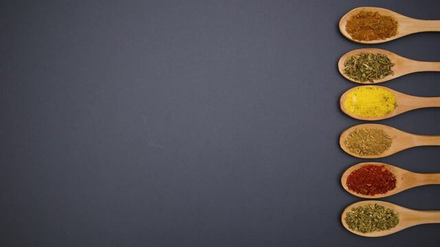 Eco friendly wooden spoons with spices moving on right side - Stop motion 