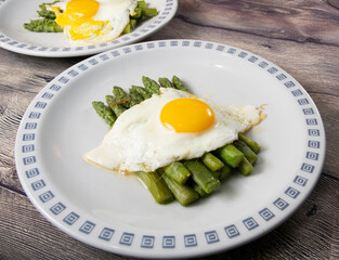 Fried egg with asparagus. Milanese traditional dish.