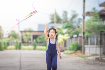 Close-up view of cute girl playing with sports (kite sport), learning outside the classroom during the summer semester and making good use of leisure time.