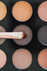 cosmetics and beauty, close-up of eyeshadow palette with neutral nude tones and brush on it