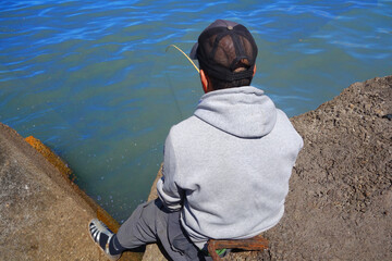 Back view of a well concentrated fisherman