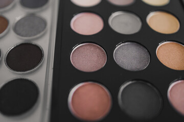 cosmetics and beauty, close-up of two similar eyeshadow palettes with neutral nude tones next to...