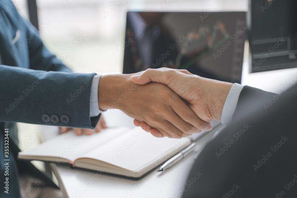 Wall mural investor shaking hand with marketing broker in investment agreement.