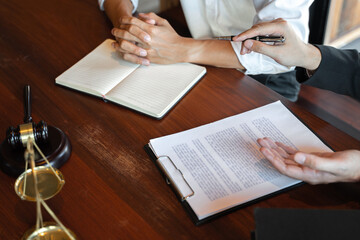 lawyer consulting with client discussing about contract.