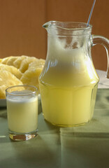 Pineapple. Juice and cut fruit set on the table.