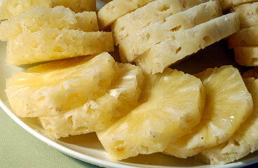Pineapple. Juice and cut fruit set on the table.