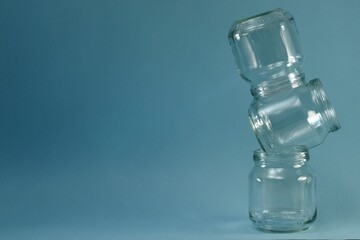 Vertical curve row of glass jars on the right on a blue background.