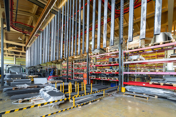 Metal parts are suspended on an overhead conveyor. Line painting in an electrostatic field