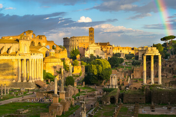 Fototapeta premium Beautiful sunset with rainbow in the Roman Forum ruins (Foro Romano) with Colosseum in the background - Rome, Italy