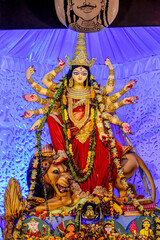 Idol of Goddess Devi Durga at a decorated puja pandal in Kolkata, West Bengal, India. Durga Puja is a famous and major religious festival of Hinduism that is celebrated throughout the world.