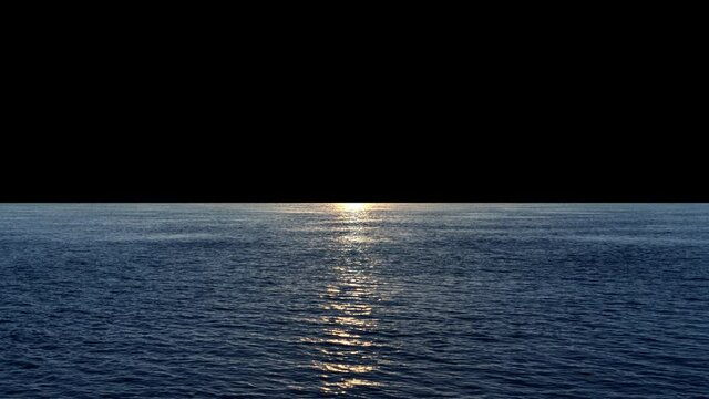 Calm sea at sunset or sunrise, sun reflection on ocean, dark black sky background