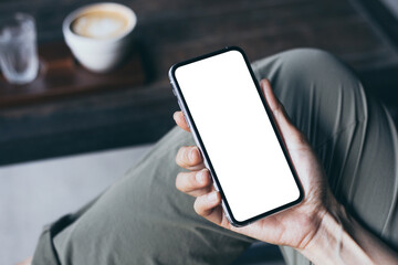 cell phone mockup image blank white screen.woman hand holding texting using mobile on desk at coffee shop.background empty space for advertise.work people contact marketing business,technology