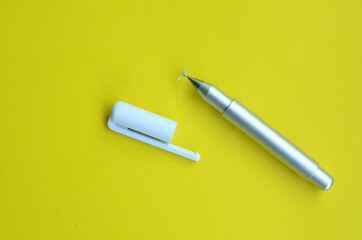 top view of the stylus pen on yellow background

