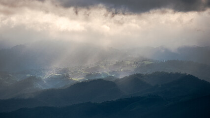 Rainy around but sun shine show up to beam through the clouds to the forest in the mountain on Doi Inthanon. Chiang Mai, Thailand.