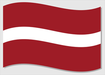 Waving flag of Latvia vector graphic. Waving Latvian flag illustration. Latvia country flag wavin in the wind is a symbol of freedom and independence.