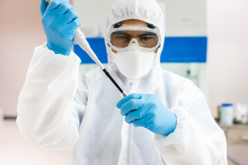 Scientists in PPE Work in an infection prevention room