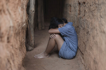 Sad girl sitting in old room. human trafficking concept.