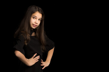 Close-up.Portrait of a cute little girl on a black background.