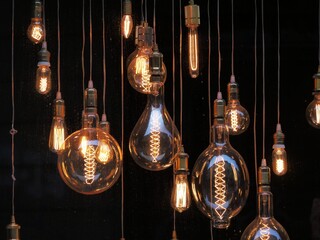 Different shaped vintage light bulbs on black background