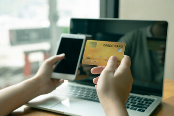 woman holding credit card and use phone for with shopping online. Online payment concept.