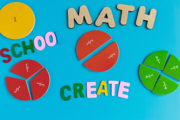 Close up mathematical fractions and colorful letters on blue background. Creative, fun mathematics...