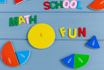 Close up mathematical fractions and colorful letters on gray background. Creative, fun mathematics...