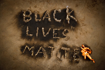 Black Lives Matter text slogan fire flames, human rights protest message revealed by black powdered soot from flaming letters, black lives matter worldwide movement, end racism concept, black history