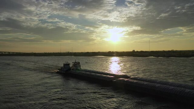 Sunrise and barges on the Mississippi River in New Orleans