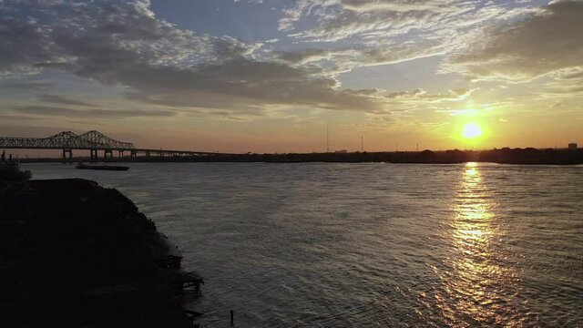 Aerial video of push boats and barge on the Mississippi River in the mornings beautiful sunrise