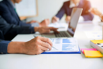 Business group or business partners discussing documents and ideas at meeting 