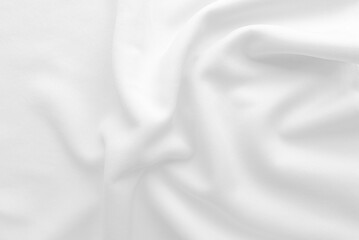 White abstract folded clothes background, fabric texture