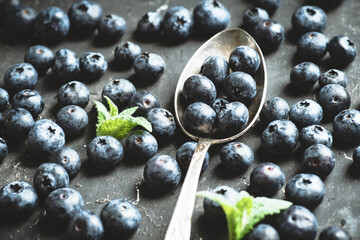 Freshly harvested blueberries on the spoon. Selective focus. Shallow depth of field.