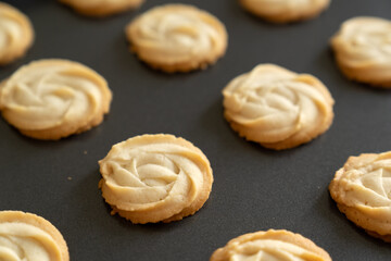 Butter cookies arrange in row in baking tray