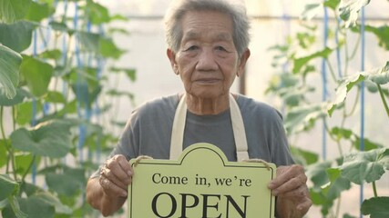 Agricultural concepts. Farmers are raising signs to invite customers in the garden. 4k Resolution.