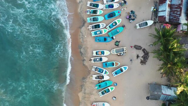 Birds Eye Aerial of Arugam Bay Beach, Sri Lanka. Indian Ocean Waves and Boats on Sandy Beachftont