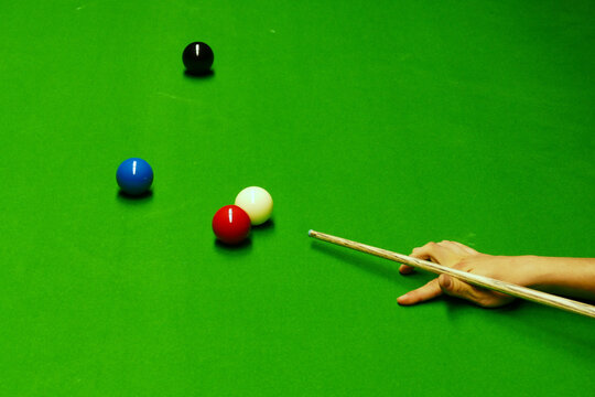 Snooker Table And Balls With Player Hitting View From Above