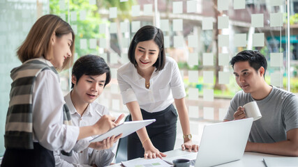 Young asian modern people in smart casual wear having meeting planning work together as a team and present ideas at work.