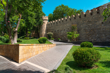Fototapeta na wymiar Alley in Governors Garden along the ancient fortress wall. Baku city, Azerbaijan
