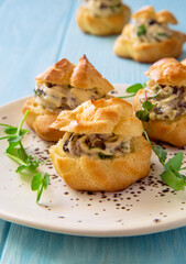 Profiteroles stuffed with cream cheese and mushrooms close up