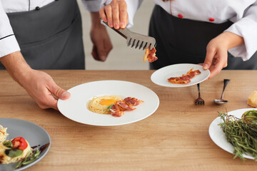 Male and female chefs cooking in kitchen
