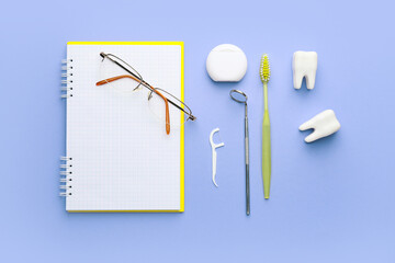 Set for oral hygiene with notebook and eyeglasses on color background