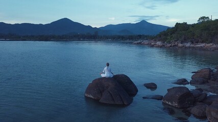 woman doing yoga and meditating in the nature