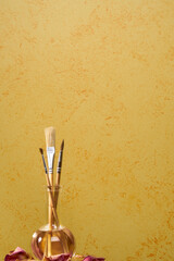 Brushes on a painted wall background. Decorative plaster. Abstract ornament.